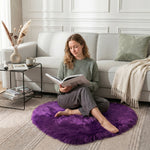 Pink heart shaped faux fur rug on a wood bedroom floor beside a bed