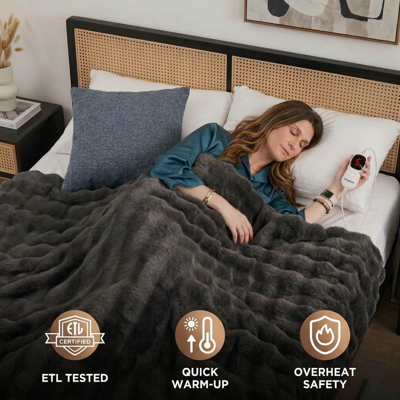 Woman sleeping in bed wrapped in the white heated throw with ETL tested, quick warm-up, and overheat safety icons