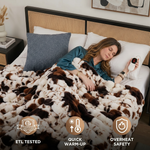 Woman sleeping in bed wrapped in the white heated throw with ETL tested, quick warm-up, and overheat safety icons