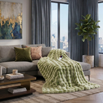 White faux rabbit fur heated blanket with bubble texture draped over a grey sofa in a modern living room