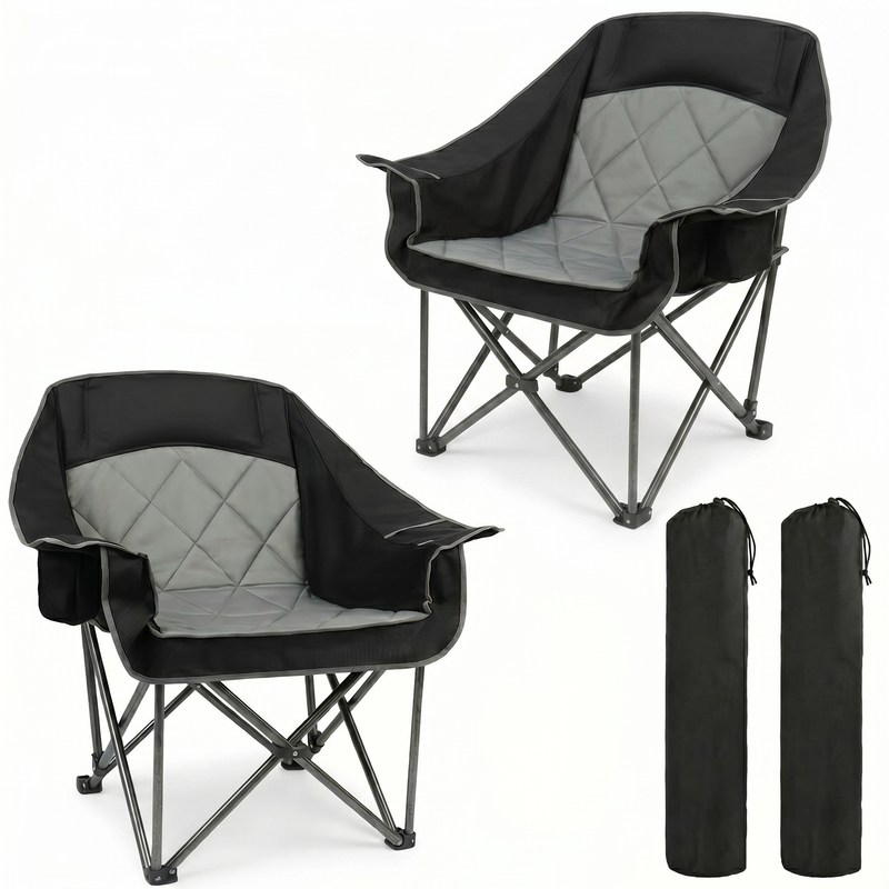 Black oversized folding camping chair with orange trim shown with two rolled carry bags on a white background