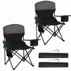 Black oversized folding camping chair with orange trim shown with two rolled carry bags on a white background