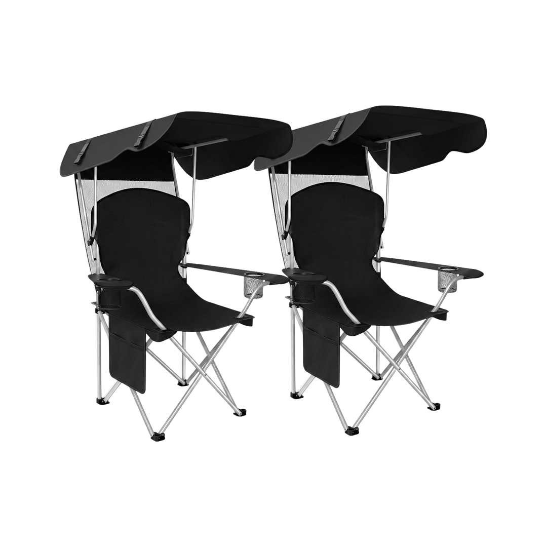 Black oversized folding camping chair with orange trim shown with two rolled carry bags on a white background