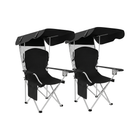 Black oversized folding camping chair with orange trim shown with two rolled carry bags on a white background