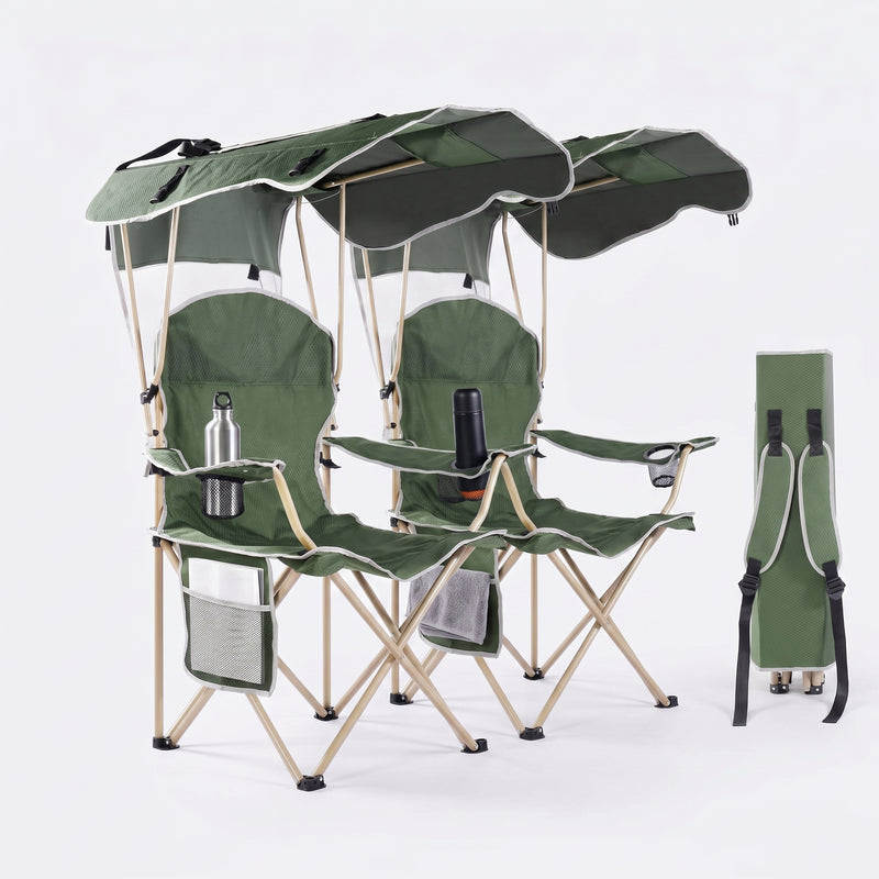 Black oversized folding camping chair with orange trim shown with two rolled carry bags on a white background