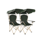 Black oversized folding camping chair with orange trim shown with two rolled carry bags on a white background