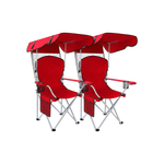 Black oversized folding camping chair with orange trim shown with two rolled carry bags on a white background