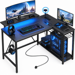 L-shaped gaming desk with LED lighting - multiple monitors and a PC setup