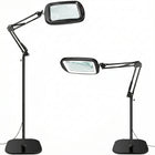 Black 10X LED magnifying lamp shown in base-mount and clamp-mount setups with USB power adapter