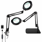 Black 10X LED magnifying lamp shown in base-mount and clamp-mount setups with USB power adapter