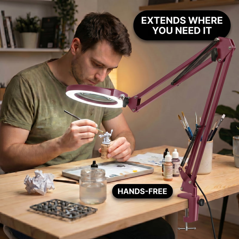 Man using a clamp-mounted LED magnifying lamp to hand-paint a miniature figure at a hobby desk