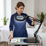 Mother and daughter using a black LED magnifying lamp on a desk for a nature journaling project