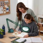 Mother and daughter using a black LED magnifying lamp on a desk for a nature journaling project