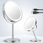 Rechargeable LED makeup mirror in chrome with lit ring light and touch control, front view