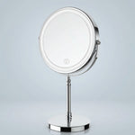 Rechargeable LED makeup mirror in chrome with lit ring light and touch control, front view