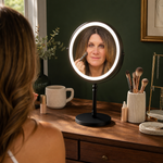 Woman applying makeup at a vanity table using the rechargeable LED makeup mirror