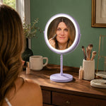 Woman applying makeup at a vanity table using the rechargeable LED makeup mirror