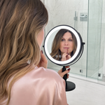 Woman applying makeup at a vanity table using the rechargeable LED makeup mirror