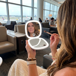 Comparison graphic showing the LED travel makeup mirror's auto-sensor lighting versus a manual-switch mirror