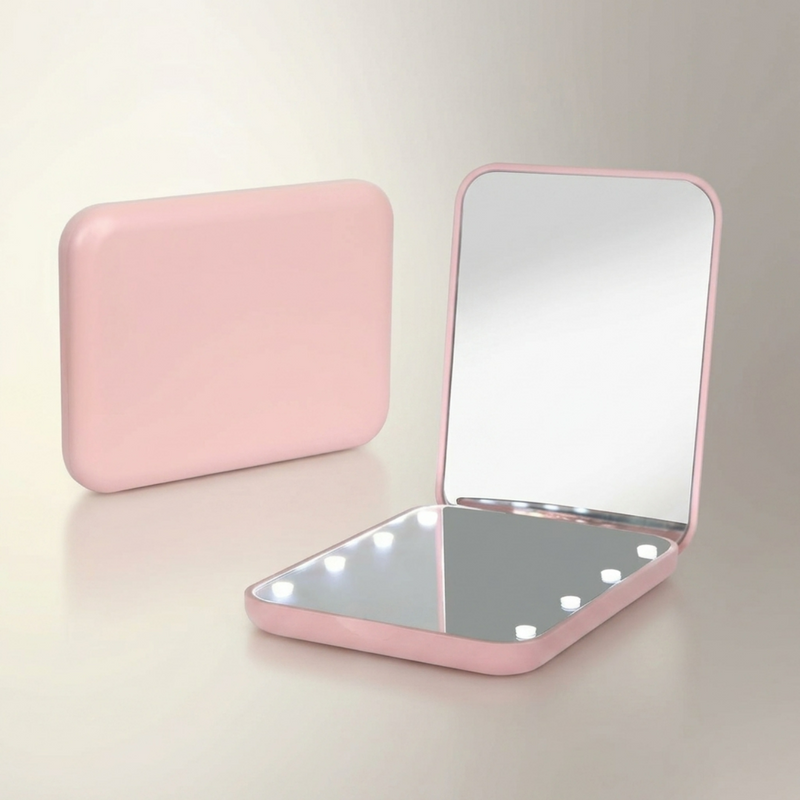 LED travel makeup mirror in pink, shown closed and open with LED lights on