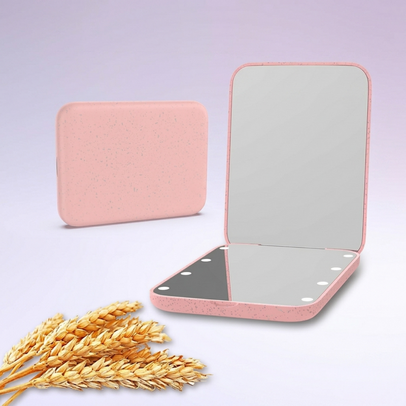 LED travel makeup mirror in pink, shown closed and open with LED lights on