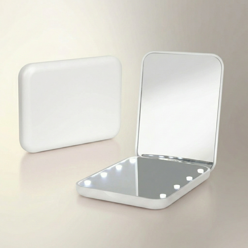 LED travel makeup mirror in pink, shown closed and open with LED lights on