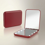 LED travel makeup mirror in pink, shown closed and open with LED lights on