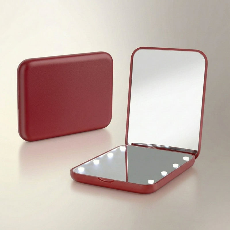 LED travel makeup mirror in pink, shown closed and open with LED lights on