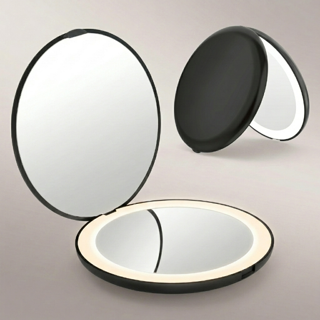 LED travel makeup mirror in pink, shown closed and open with LED lights on