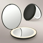 LED travel makeup mirror in pink, shown closed and open with LED lights on