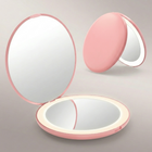 LED travel makeup mirror in pink, shown closed and open with LED lights on