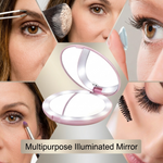 Pink LED travel makeup mirror being carried in a pocket, showing its compact size