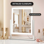 White LED vanity mirror with edge lighting and attached 20X magnifier on a marble vanity table