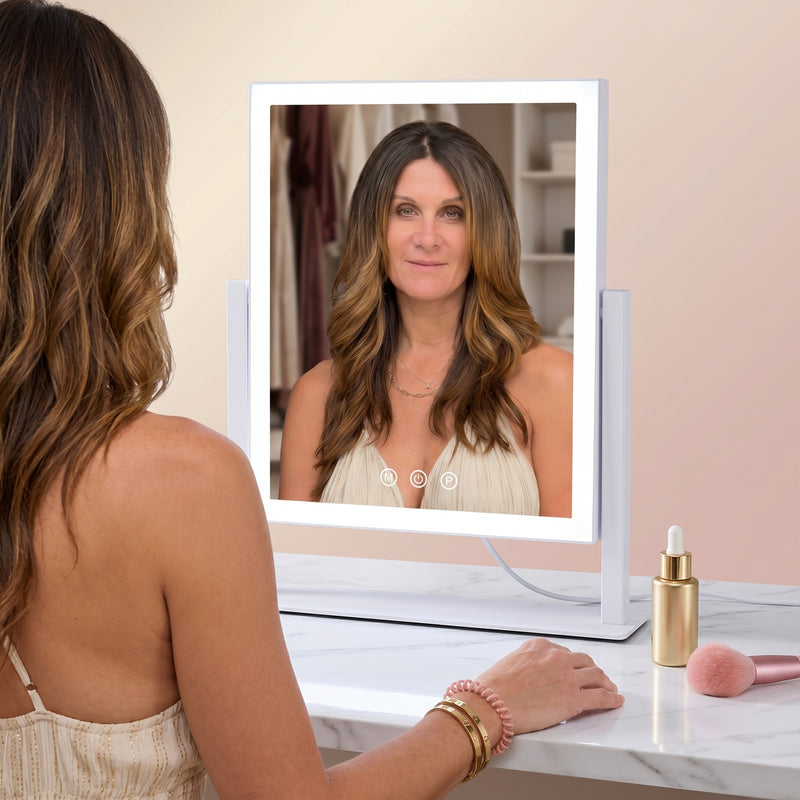 Woman viewing her eye in the 20X magnifier attached to the LED vanity mirror