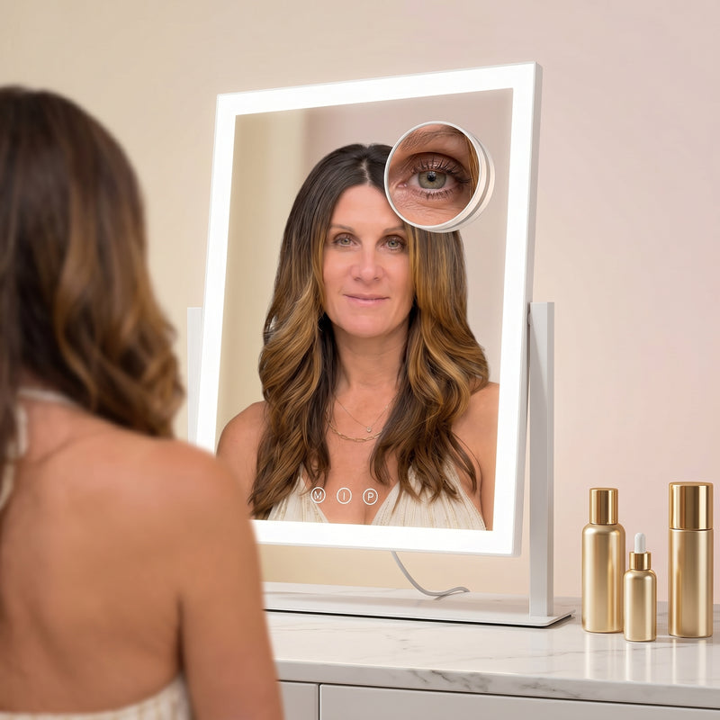 Woman viewing her eye in the 20X magnifier attached to the LED vanity mirror