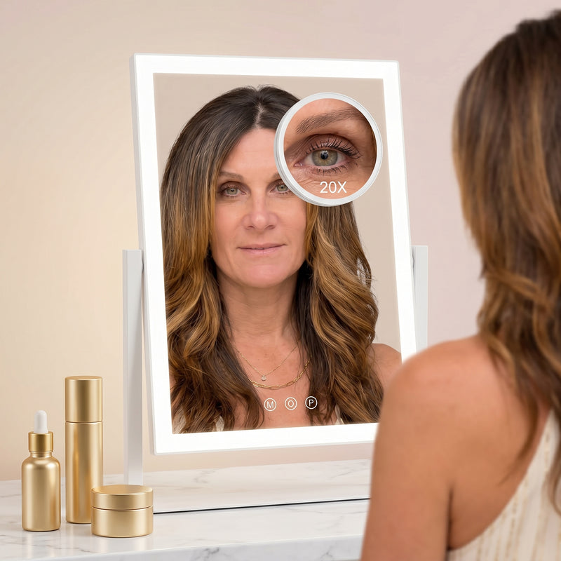 Woman viewing her eye in the 20X magnifier attached to the LED vanity mirror
