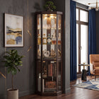 Oak lighted corner curio cabinet displaying crystal and glassware in a living-room corner