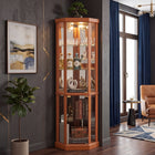 Oak lighted corner curio cabinet displaying crystal and glassware in a living-room corner