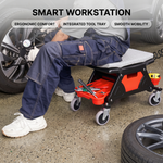 Person detailing a grey car beside the rolling mechanic stool with five swivel casters