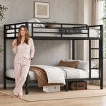 Adult standing beside a black metal bunk bed showing its full-size scale