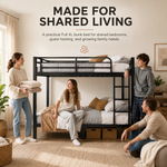 Four adults around a black metal bunk bed in a shared bedroom