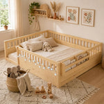 Natural wood Montessori floor bed with fence rails styled in a child's room