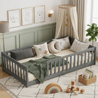 Natural wood Montessori floor bed with fence rails styled in a child's room
