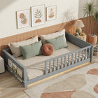 Natural wood Montessori floor bed with fence rails styled in a child's room