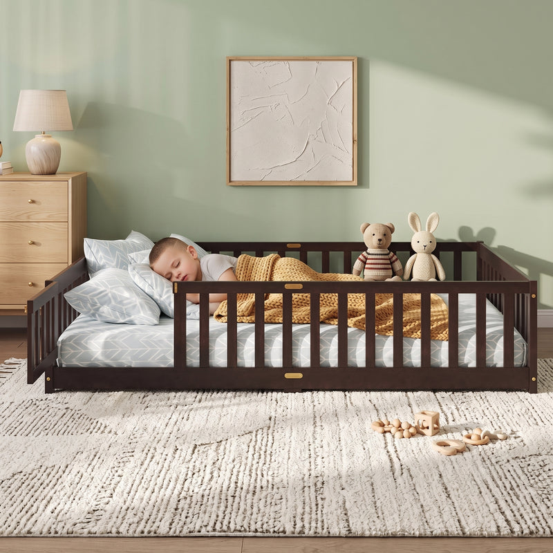 Toddler resting on a natural Montessori floor bed with fence in a forest-themed nursery