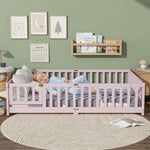 Toddler resting on a natural Montessori floor bed with fence in a forest-themed nursery