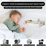 Toddler resting on a natural Montessori floor bed with fence in a forest-themed nursery