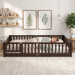 Toddler resting on a natural Montessori floor bed with fence in a forest-themed nursery