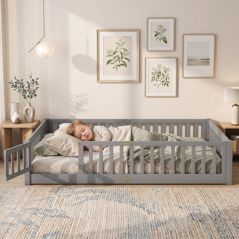 Toddler resting on a natural Montessori floor bed with fence in a forest-themed nursery