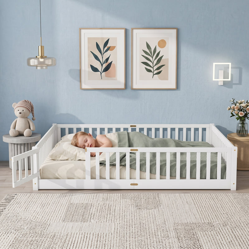 Toddler resting on a natural Montessori floor bed with fence in a forest-themed nursery